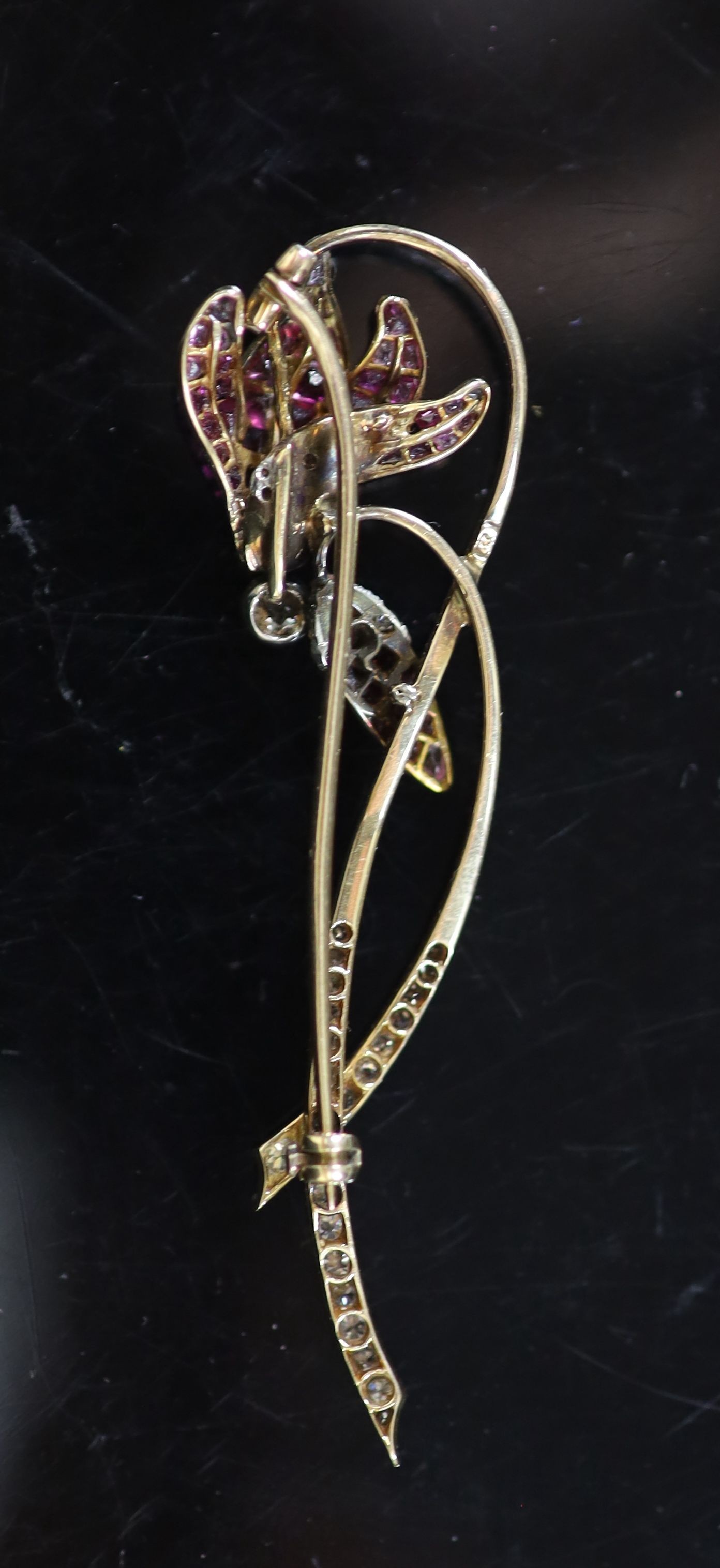 A mid 20th century, gold and platinum graduated ruby and diamond set foliate brooch, in gilt tooled fitted leather case